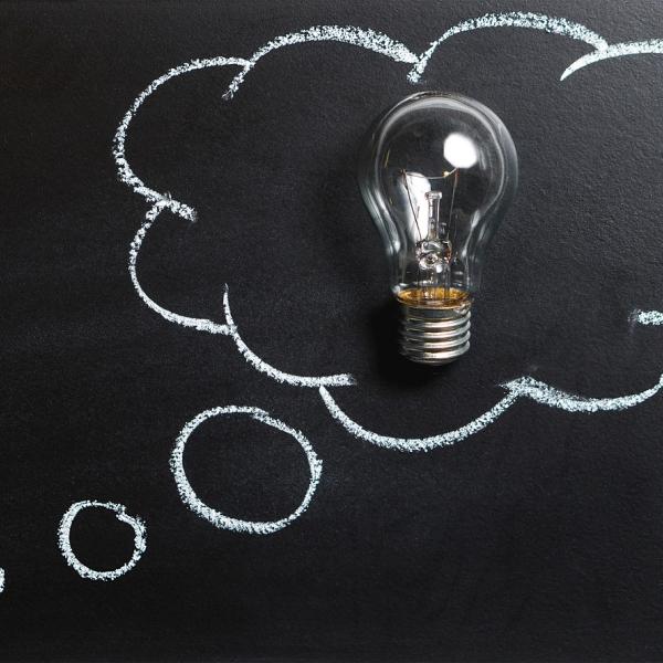 Lightbulb in a thought bubble on a blackboard